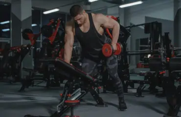 entraînement musculaire 3 fois par semaine Personne en tenue de sport soulevant des poids lors d’un entraînement de musculation trois fois par semaine — séance fitness, force musculaire, routine régulière, musculation, corps tonique et bien-être